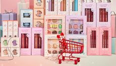 A selection of ColourPop beauty products displayed behind a red shopping cart
