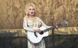 Country music recording artist Dolly Parton performs on stage during the 'Pure & Simple' tour