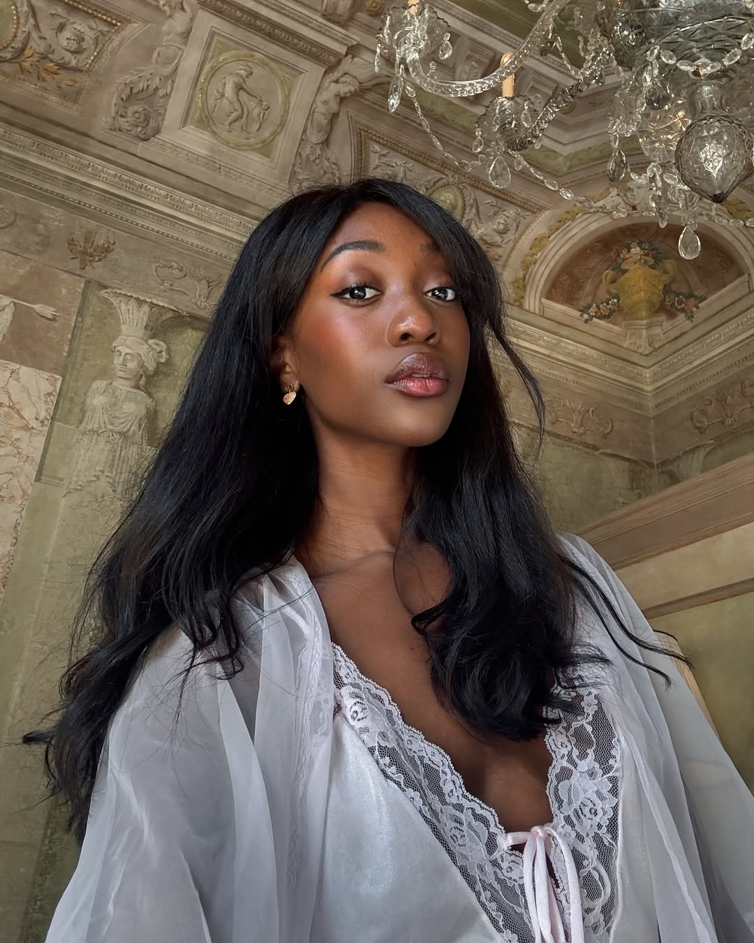 Emmanuelle Koffi with glowy skin and berry-toned blush