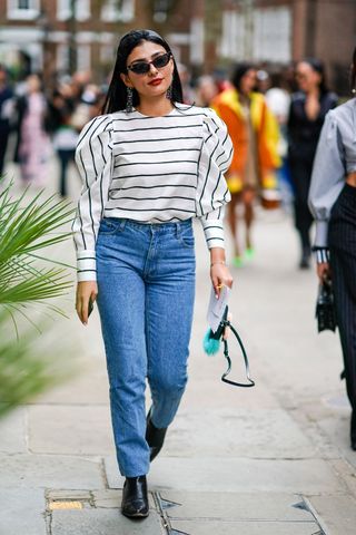 a street style influencer wearing a striped top
