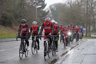 A group of cyclists out riding in the snow
