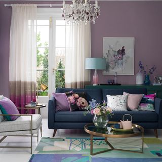 Purple living room and blue sofa with chandelier