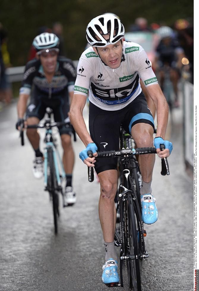 Chris Froome (Team Sky) walks onto the stage two podium after winning atop Col du Beal
