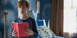 Jaeden Lieberher holding a book