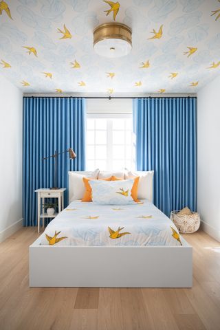 A kid's bedroom with central lighting complemented with bedside lights