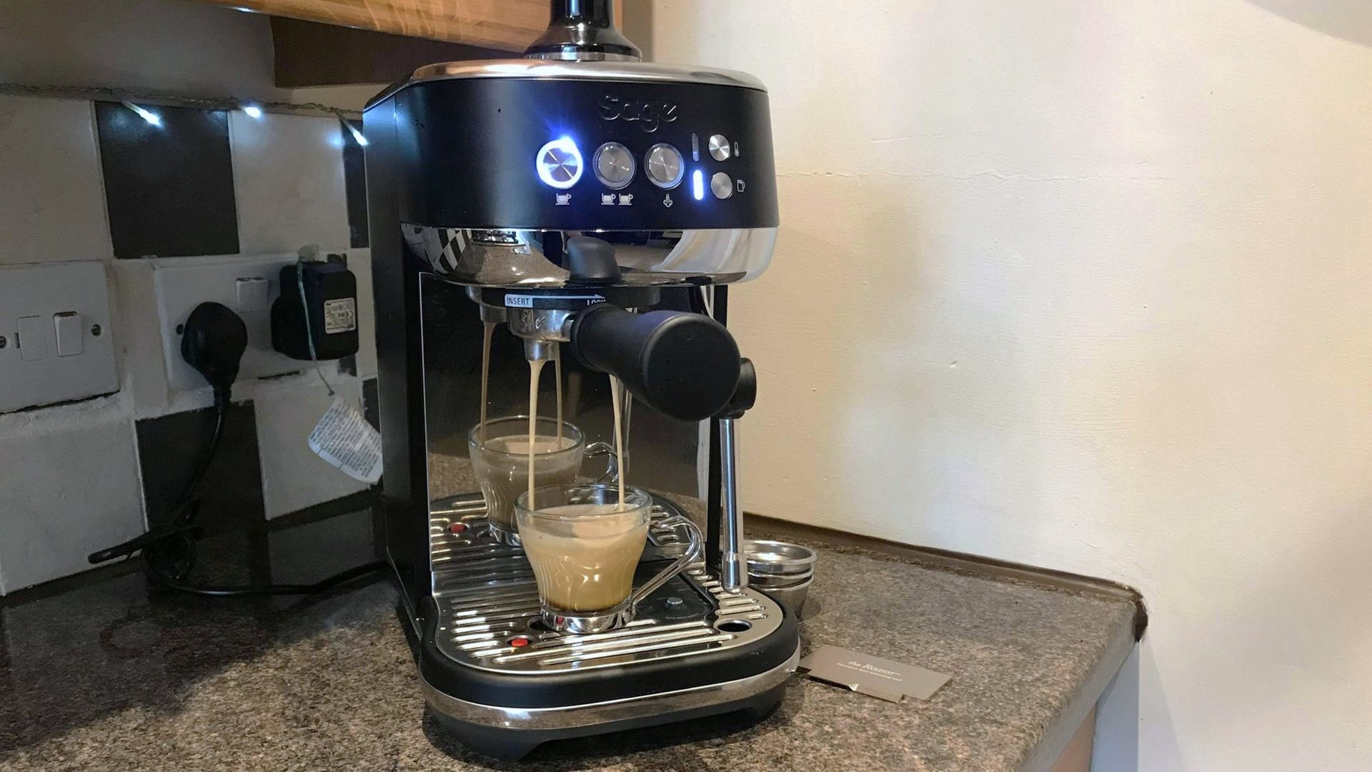 Breville Bambino Plus coffee maker on kitchen counter