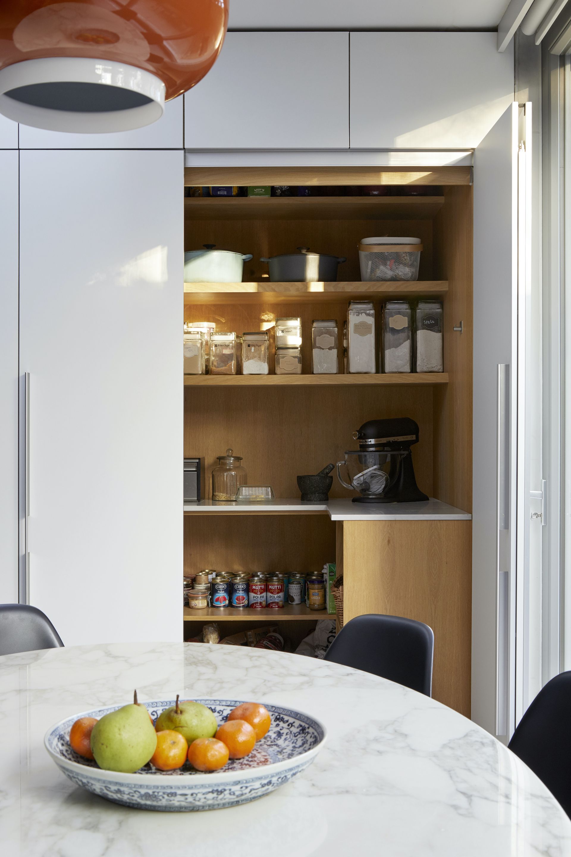 open pantry cupboard with labelled storage inside