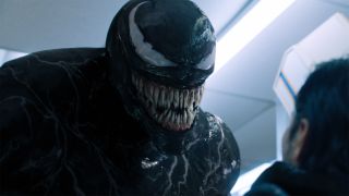 Venom (Tom Hardy) threatens a customer in Venom