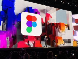 A man talking on stage at Adobe Max 2022 with the Figma logo in the background