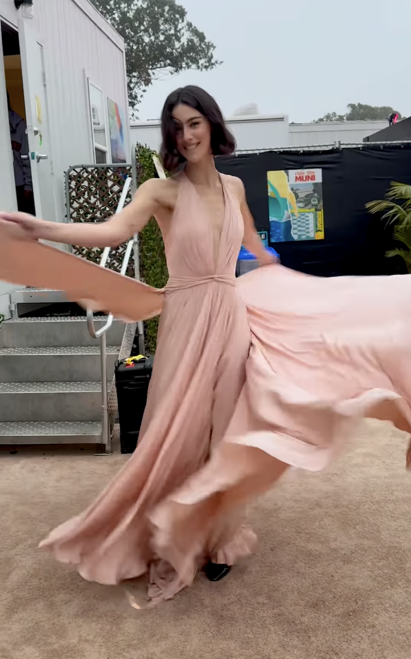 Gracie Abrams wearing a custom GapStudio by Zac Posen blush pink cape dress