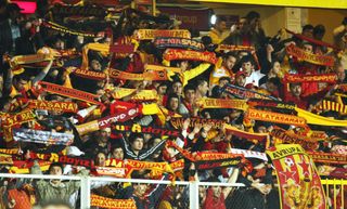 Galatasaray fans hold up scarves during a game against Fenerbahce at the Ali Sami Yen Stadium in February 2008.