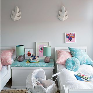 white kids room with twin beds and wall lights