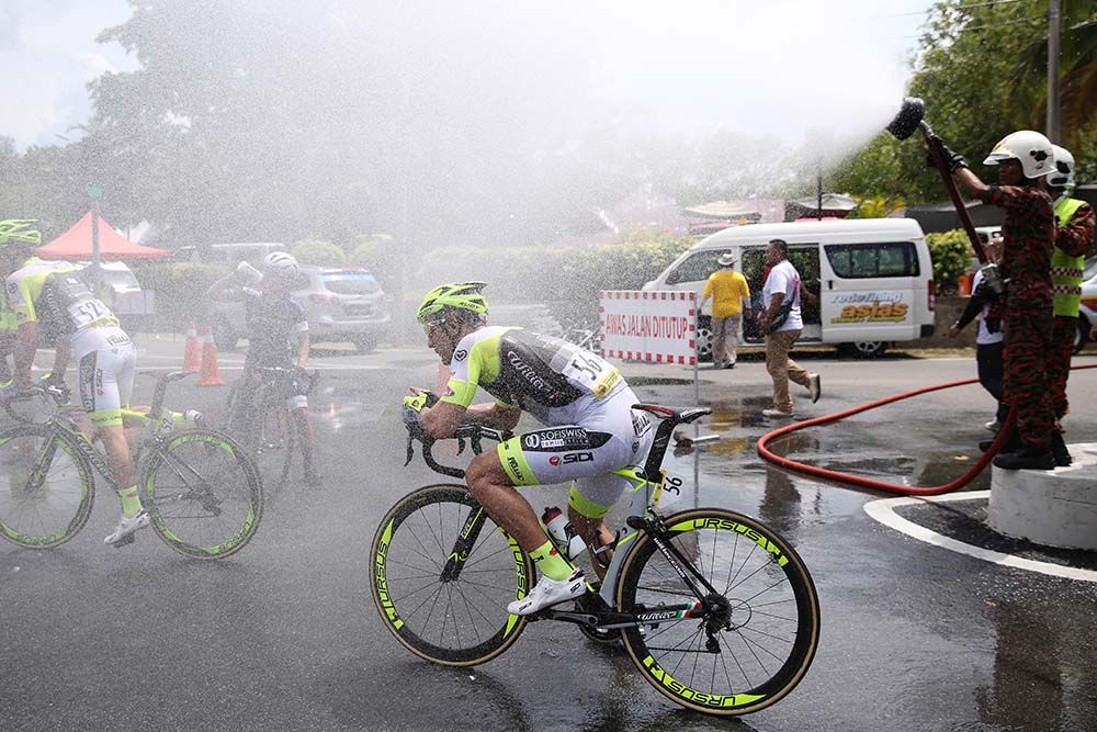 Riders enjoy a cooling water spray