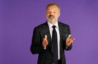 Graham Norton against a purple backdrop