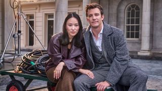 Luke Thompson and Yerin Ha sit on the set of Bridgerton season 4 