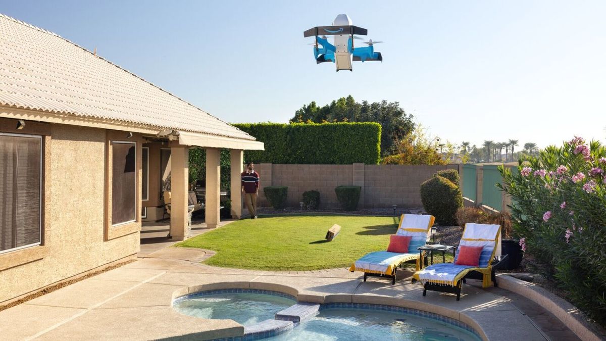 Image of Amazon's MK30 delivery drone dropping a cushioned Amazon parcel from 13 feet up onto a garden lawn.
