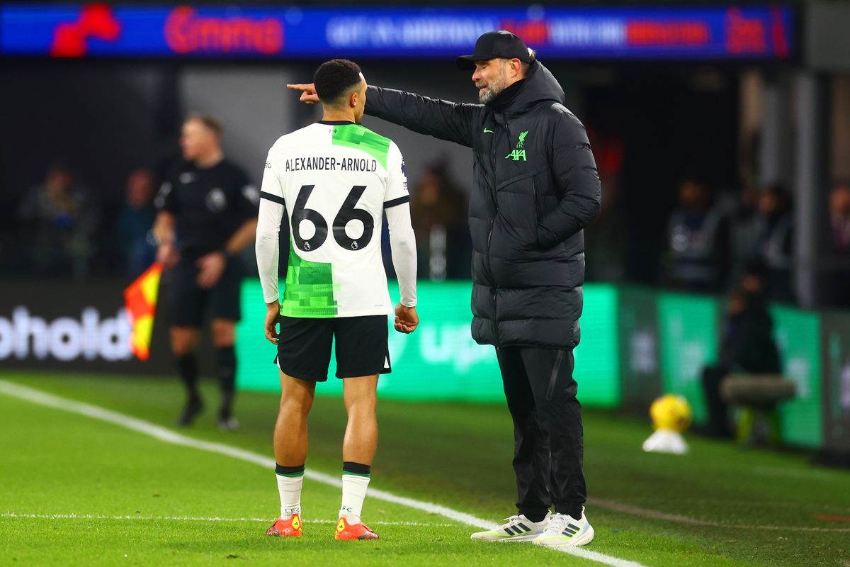 Liverpool boss Jurgen Klopp delivers instruction the way of Trent Alexander-Arnold.