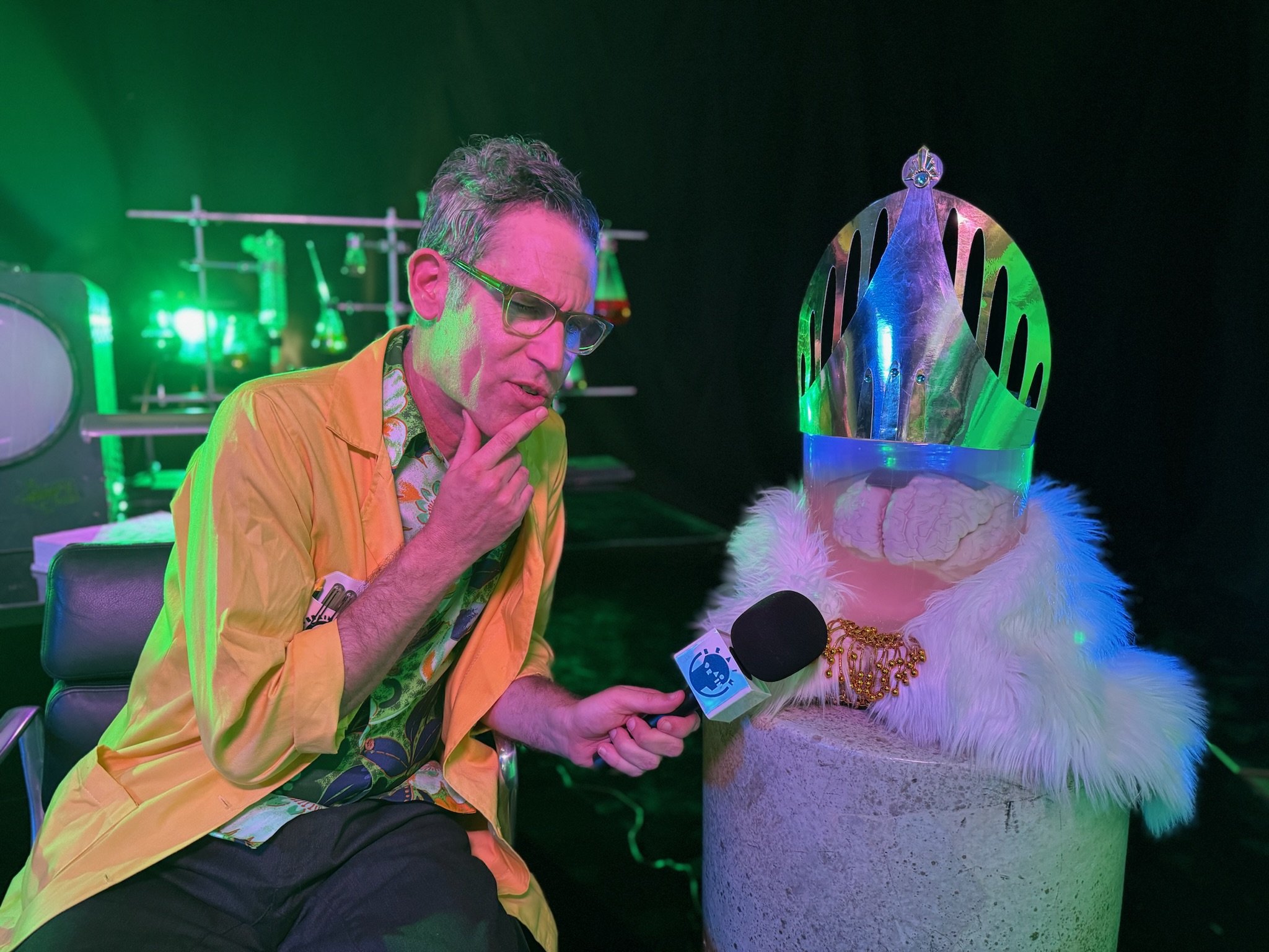 Blippo+; Actor Cosmo Segurson shares a thoughtful moment with one of the prop brains on set at Telefantasy Studios.