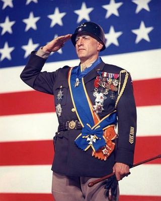 George C. Scott as General George Patton wearing a military jacket with badges and saluting in the movie patton