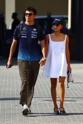 Alexander Albon of Thailand and Williams and Lily Muni He walk in the Paddock prior to practice ahead of the F1 Grand Prix of Abu Dhabi at Yas Marina Circuit on December 06, 2024 in Abu Dhabi, United Arab Emirates.