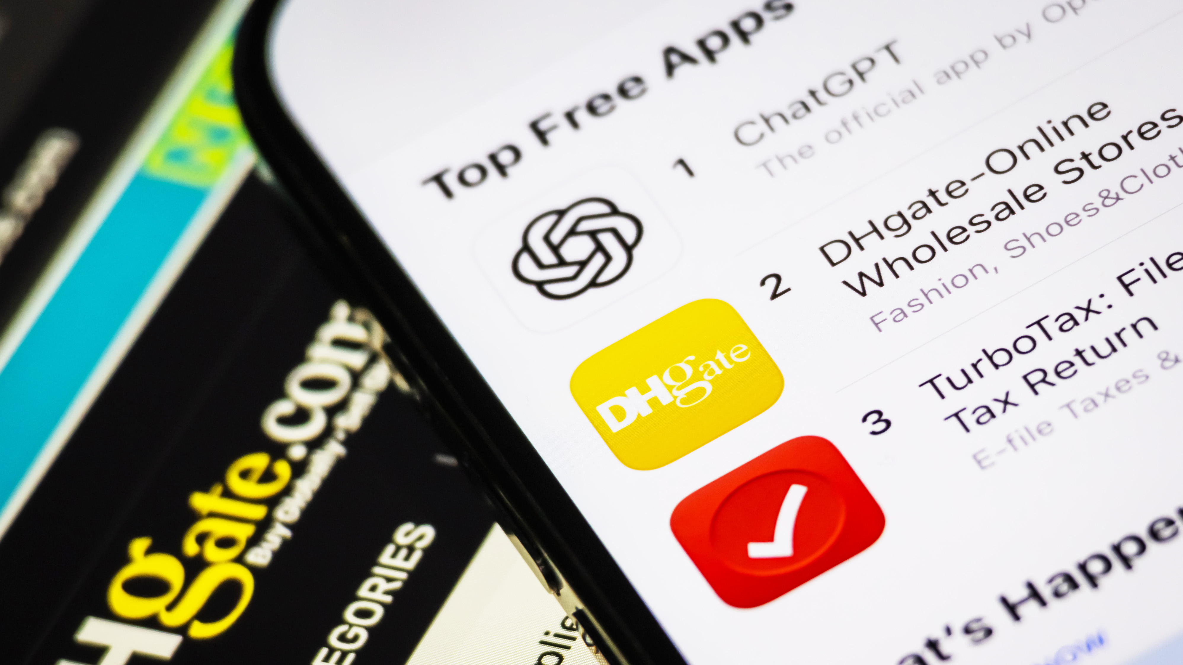 CHONGQING, CHINA - APRIL 15: In this photo illustration, the DHgate app is shown ranked second on the Top Free Apps chart in the Apple App Store, just below ChatGPT and above TurboTax, while part of the DHgate website interface is visible in the background, on April 15, 2025 in Chongqing, China. The Trump trade war has gone viral on TikTok, pushing a Chinese e-commerce app, DHgate, to the No. 2 spot on the US App Store&#039;s free iPhone apps chart. (Photo by Cheng Xin/Getty Images)