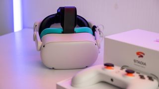 A Meta Quest 2 headset in focus and the Google Stadia controller and box out of focus