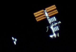 The Space Shuttle advancing on the International Space Station (ISS) in an Earth orbit at 350 km as seen as through a 4,200 millimeter refractor telescope in Germany.