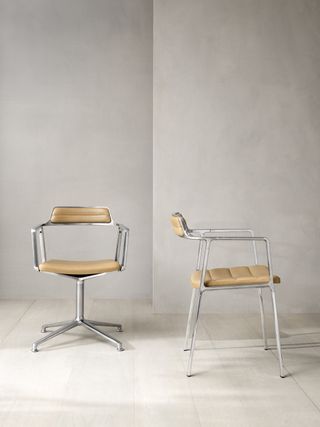 A gray metal and beinge leather office chair, without wheels. Photographed from the front and from the side.