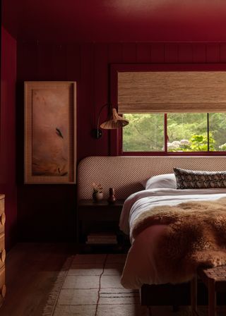 red color drenched bedroom with bamboo blinds