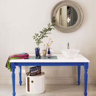 bathroom table with mirror and flower vase
