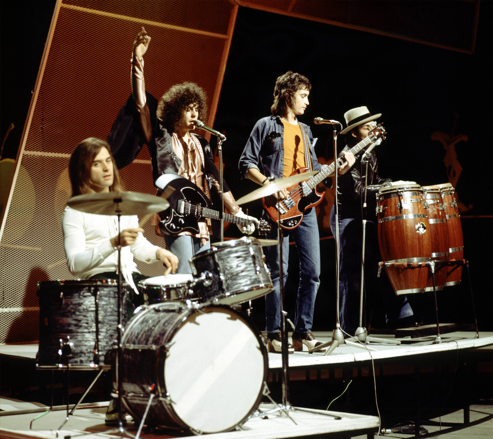 From left, drummer Bill Legend, singer and guitarist Marc Bolan (1947-1977), bass guitarist Steve Currie (1947-1981) and percussionist Mickey Finn (1947-2003) of English glam rock group T Rex perform the band&#039;s new single &#039;The Groover&#039; on the BBC music television show &#039;Top of the Pops&#039; at BBC Television Centre in London, June 1973.
