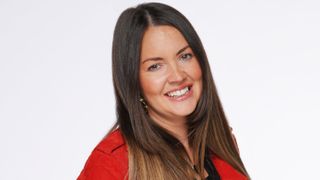 EastEnders star Lacey Turner as Stacey Slater wearing her hair down and a red jacket 