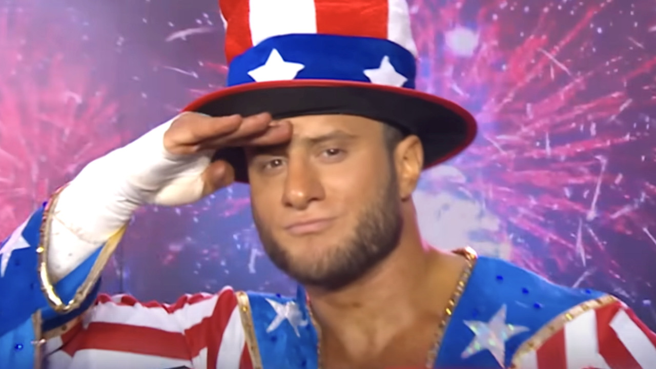Maxwell Jacob Friedman saluting while wearing Uncle Sam hat and U.S. Flag costume in AEW All In London