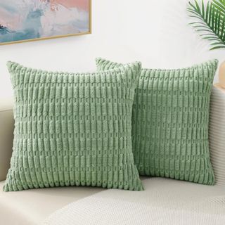 Green textured throw pillows on a sofa