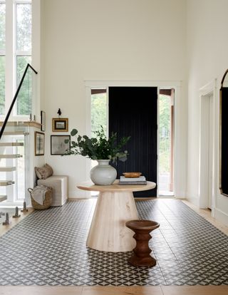 an entryway with a tiled floor section
