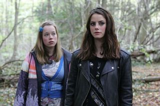 kaya scodelario as effy standing in the woods with another girl on skins