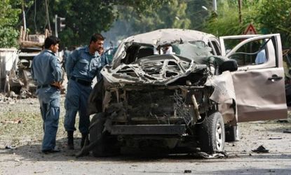 Afghan policemen inspect a vehicle hit by a bomb blast in Jalalabad province, Afghanistan, Aug. 13. 