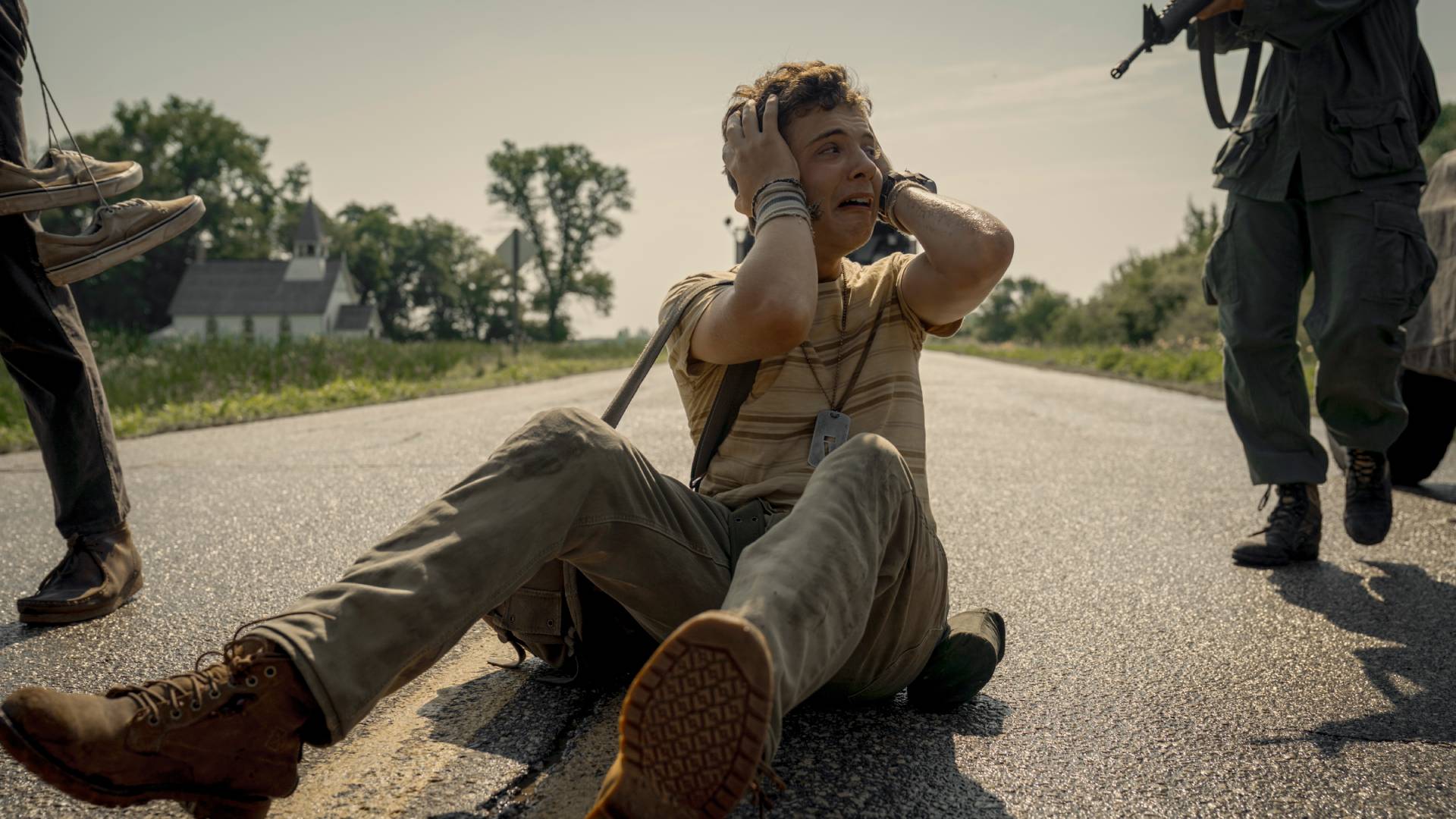 Roman Griffin Davis on the ground at gunpoint in The Long Walk