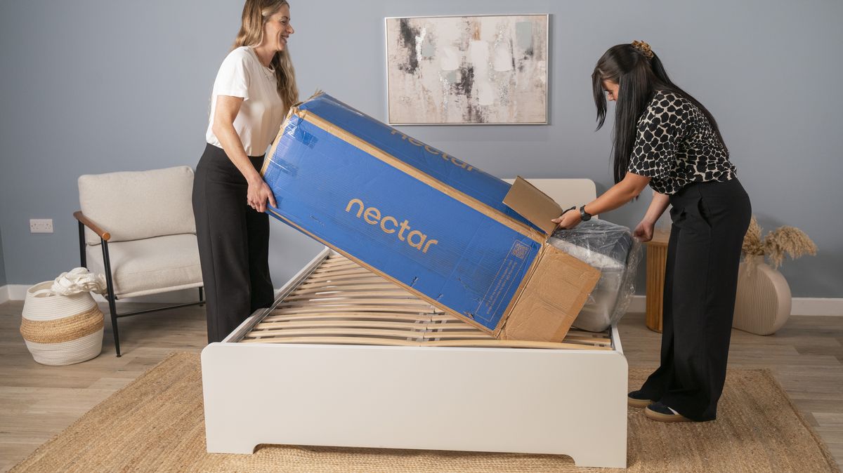 Two Toms Guide mattress testers unbox the Nectar Luxe mattress onto a bed frame