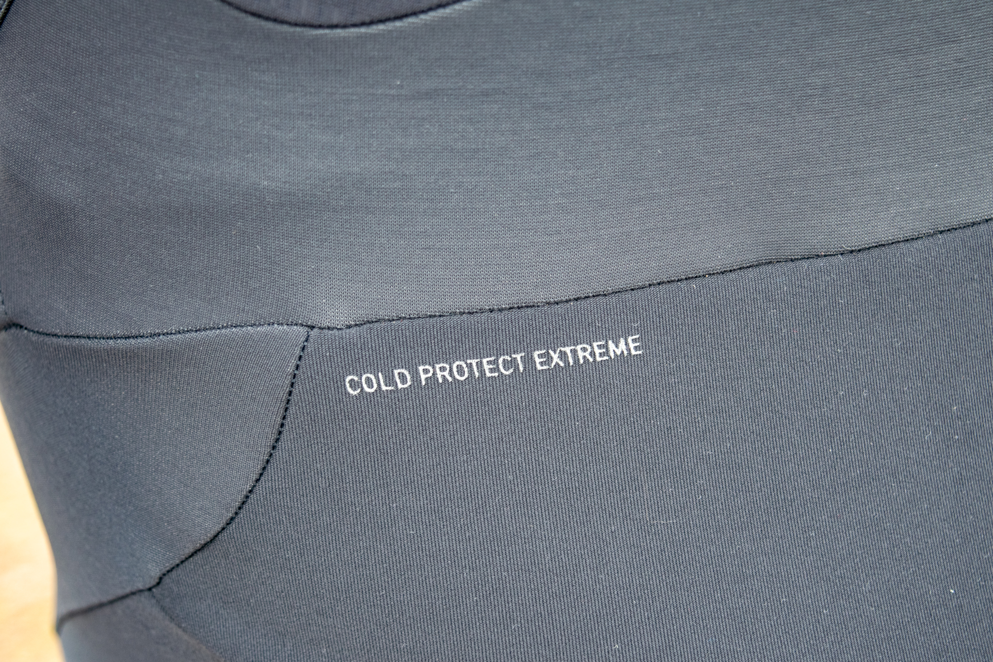 A 'cold extreme protect' bibtight wordmark