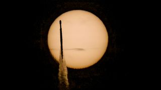 A rocket transits the sun 