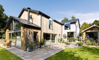 modern house exterior with woodclad and pebble dash walls