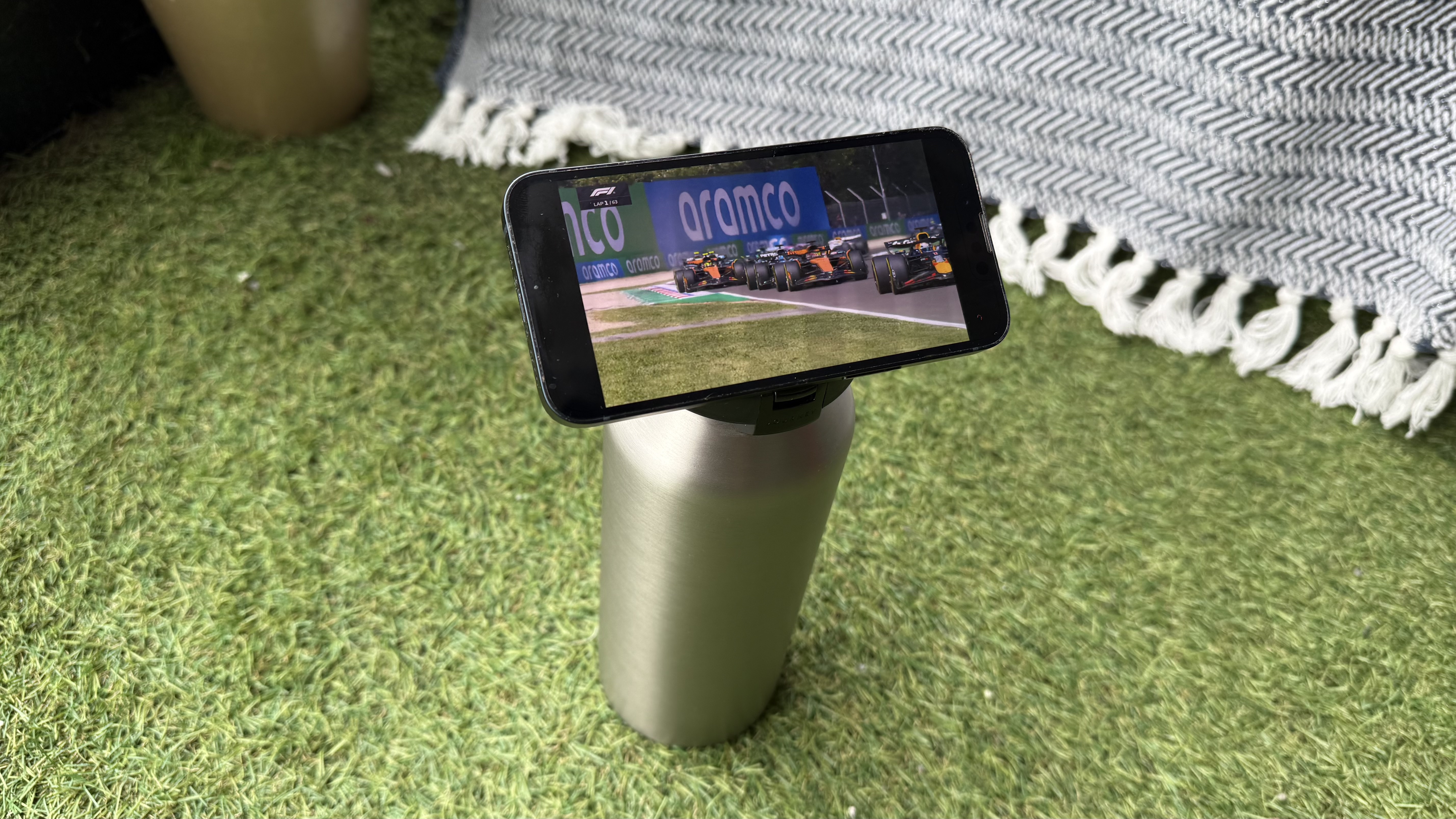The Journey Reevus water bottle on a faux-grass surface