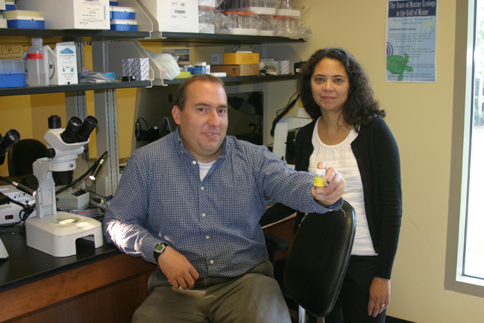 Jon Allen and his collaborator, Aurora Esquela-Kerscher, pose with Buddy, now preserved in a jar.