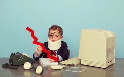 A young boy dressed up in business suit sits at his desk after being beat up by the unpredictable economy. He is wearing a neck brace and has a black eye with glasses crooked wile holding a r