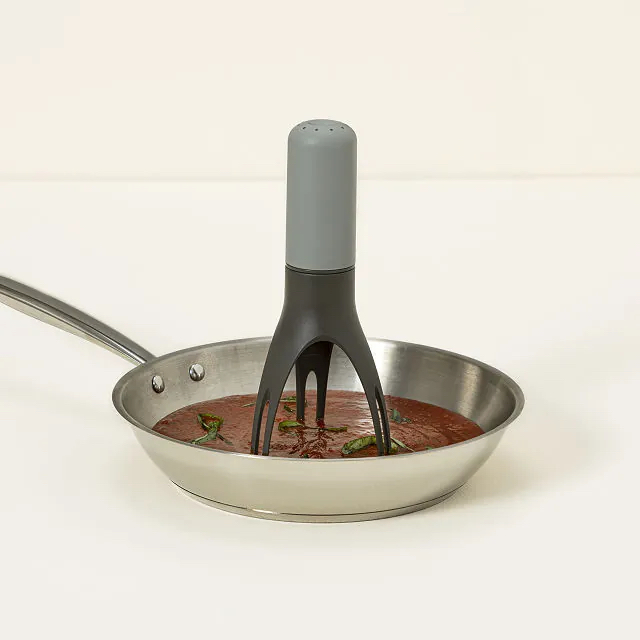 An automatic pan stirrer inside a stainless steel pan