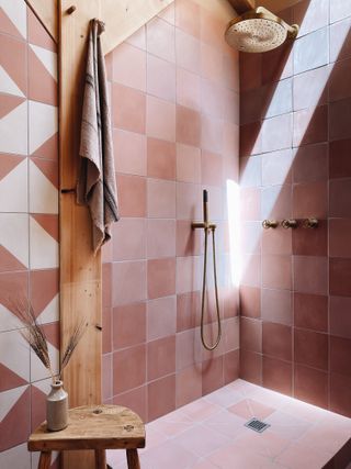 Bathroom design with a mix of pink tiles by The Landscape Lodge