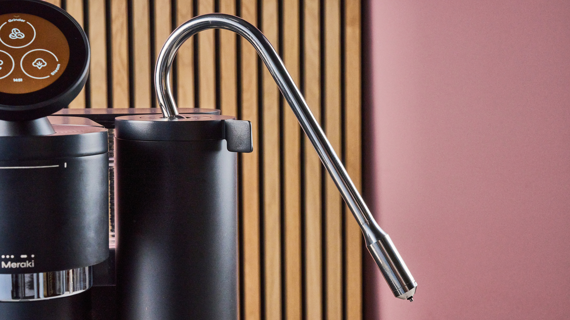 A closeup of the steam wand flexed at a 30 degree angle of the Meraki Espresso Machine.