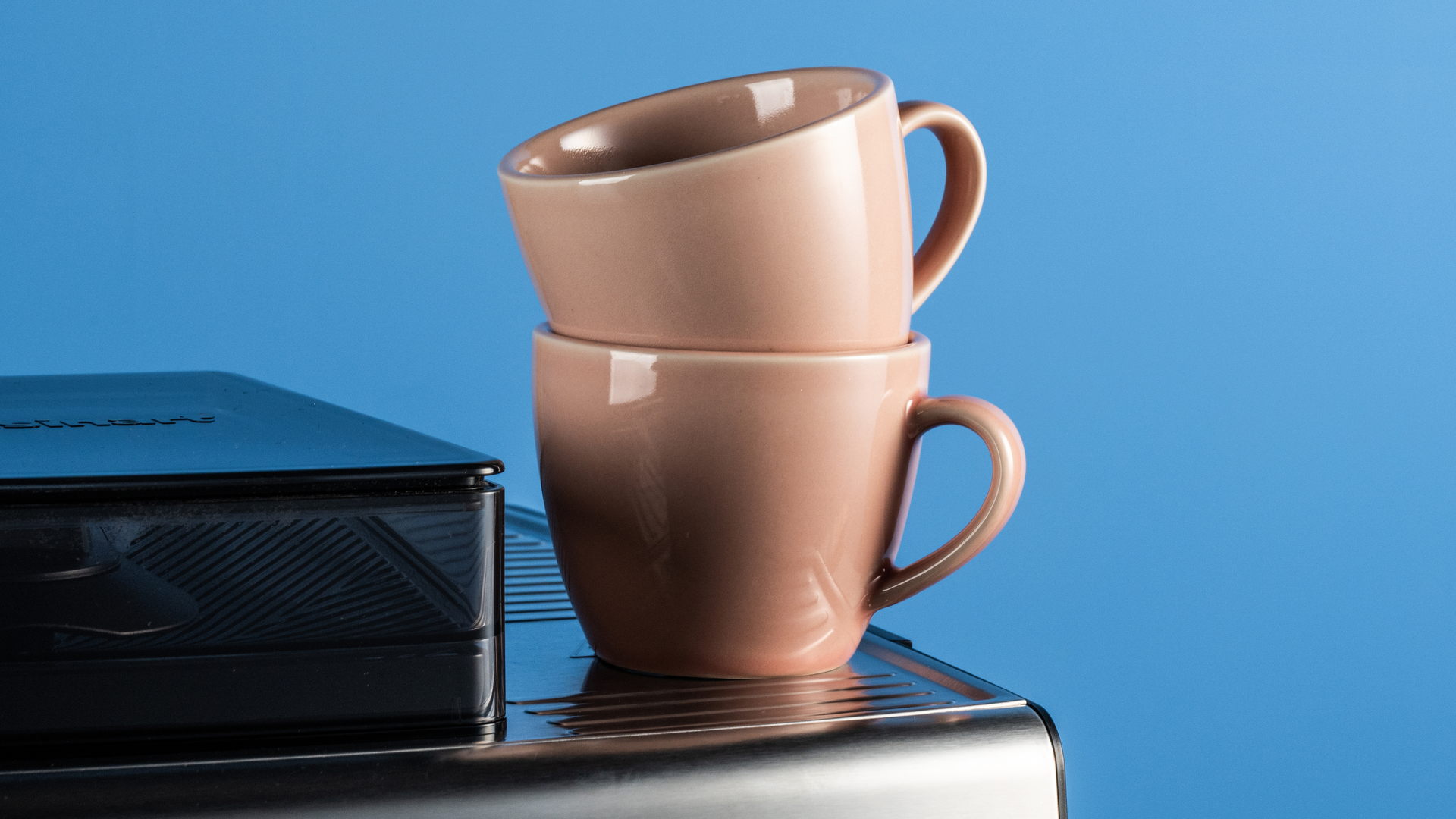 the cuisinart grind, tamp and brew espresso machine with built-in grinder photographed against a blue tom's guide background