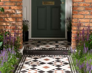 patterned tile pathway leading to a front door